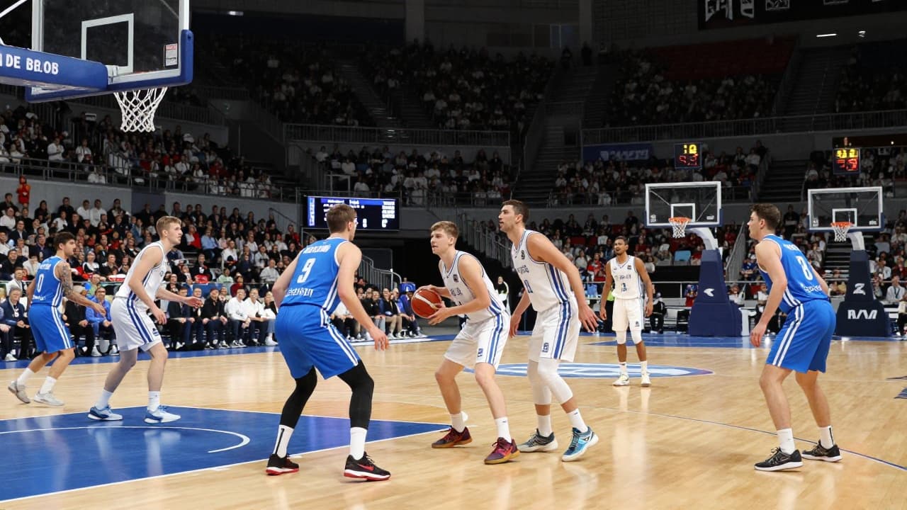 Basketball players in blue and white kits in action