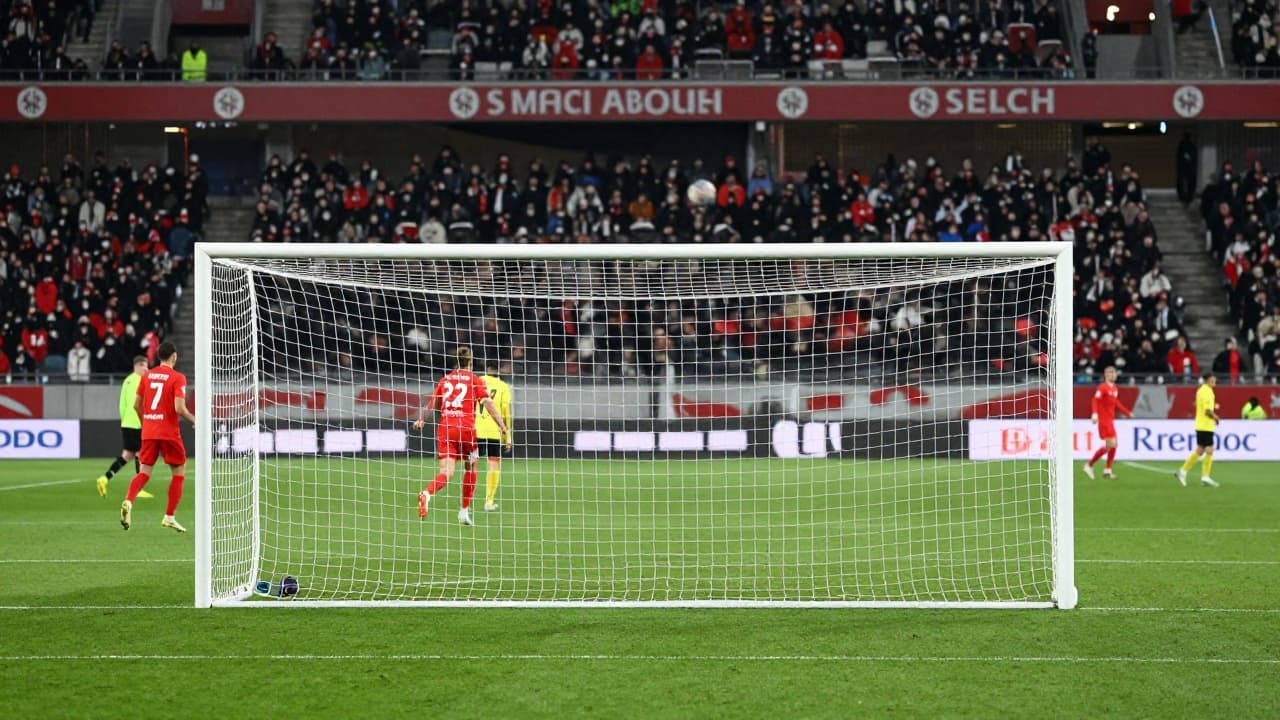 Empty goal and ball at a Swiss stadium