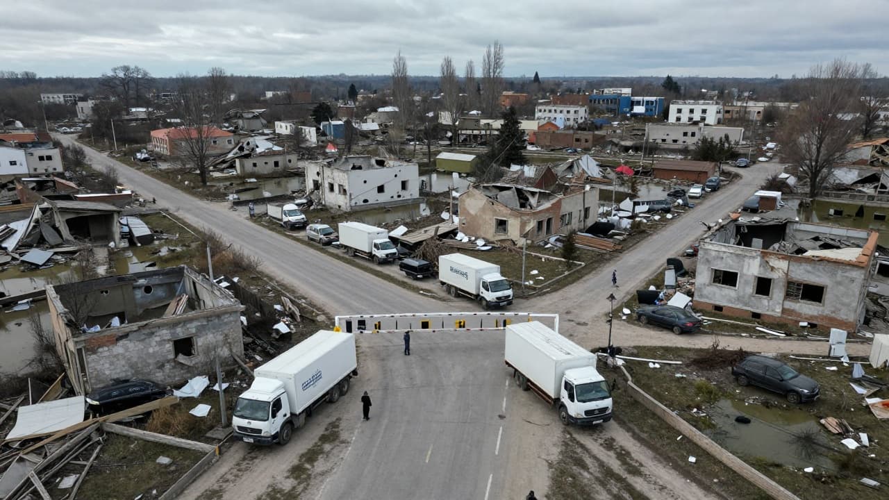 Humanitarian aid waits at a damaged site