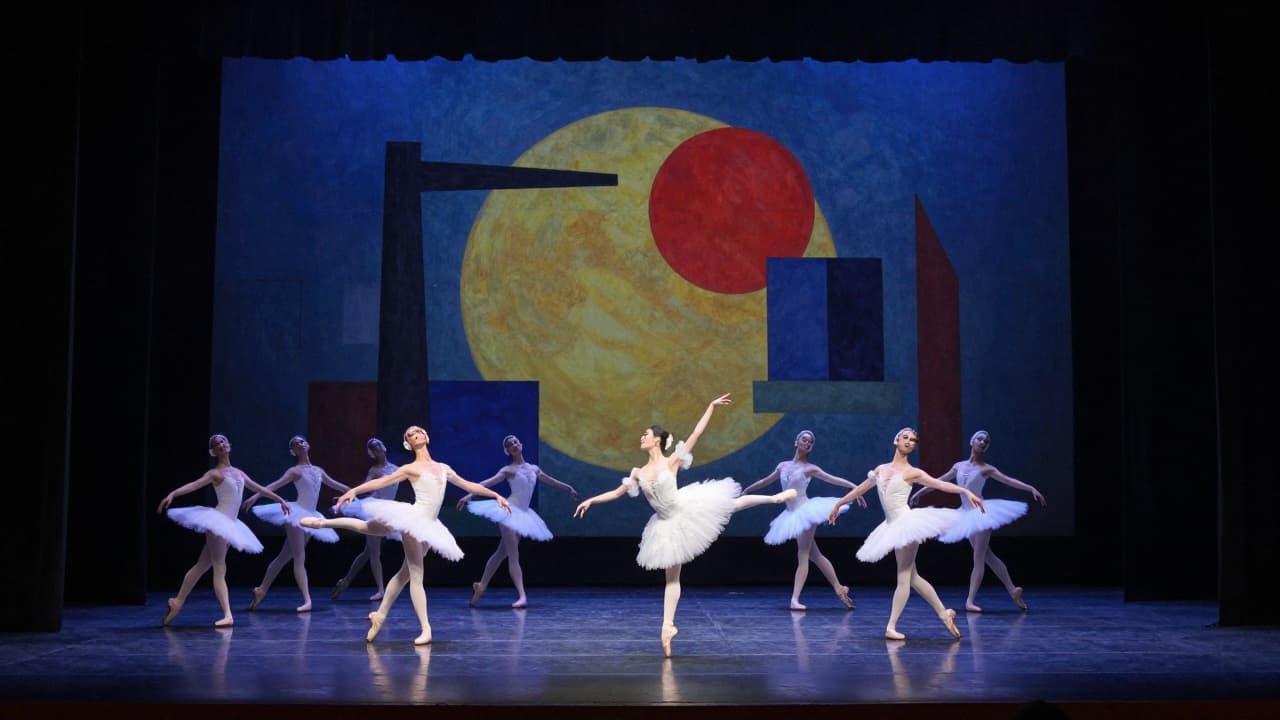 Dancers in motion under stage lighting